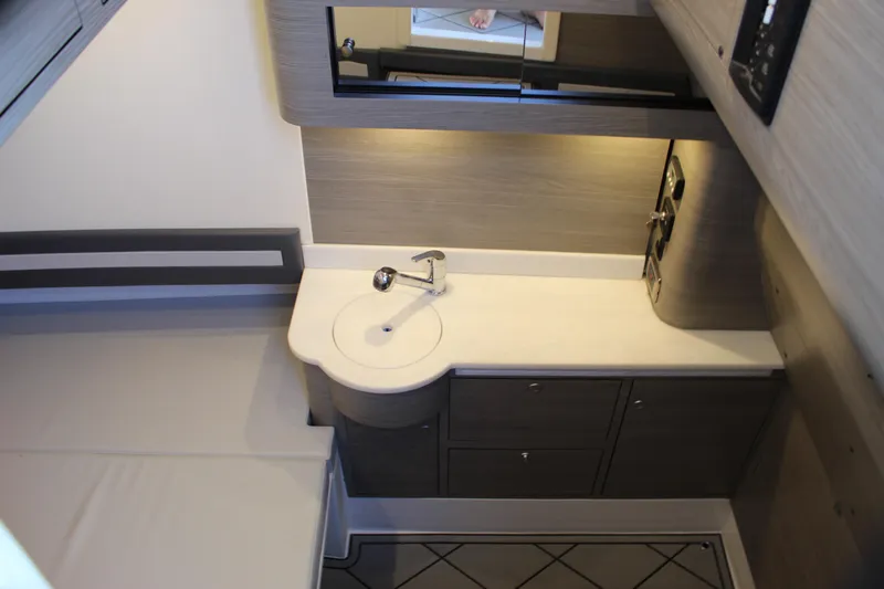  Yacht Photos Pics Modern bathroom interior in 2021 Mystic M4200 yacht, featuring sleek sink and cabinetry.