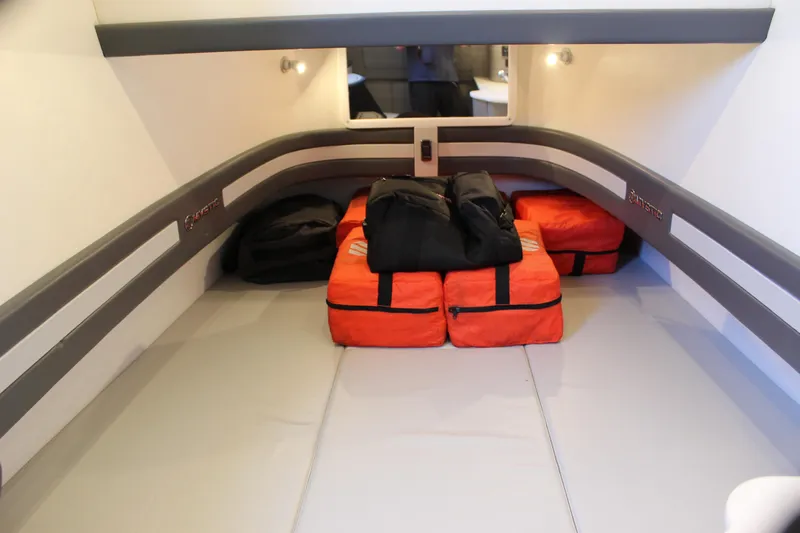  Yacht Photos Pics Interior cabin of 2021 Mystic M4200 with orange and black bags on the floor.