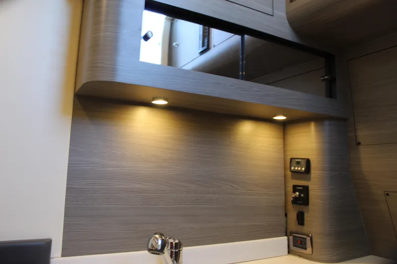  Yacht Photos Pics Modern interior of Mystic M4200 yacht, 2021 model, featuring sleek wood paneling and ambient lighting.