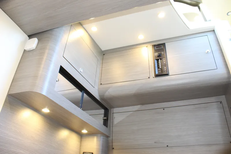  Yacht Photos Pics Modern interior of 2021 Mystic M4200 boat with sleek cabinetry and recessed lighting.
