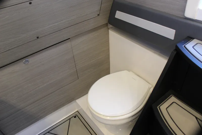  Yacht Photos Pics Modern bathroom interior in 2021 Mystic M4200 boat, featuring sleek design and compact toilet.