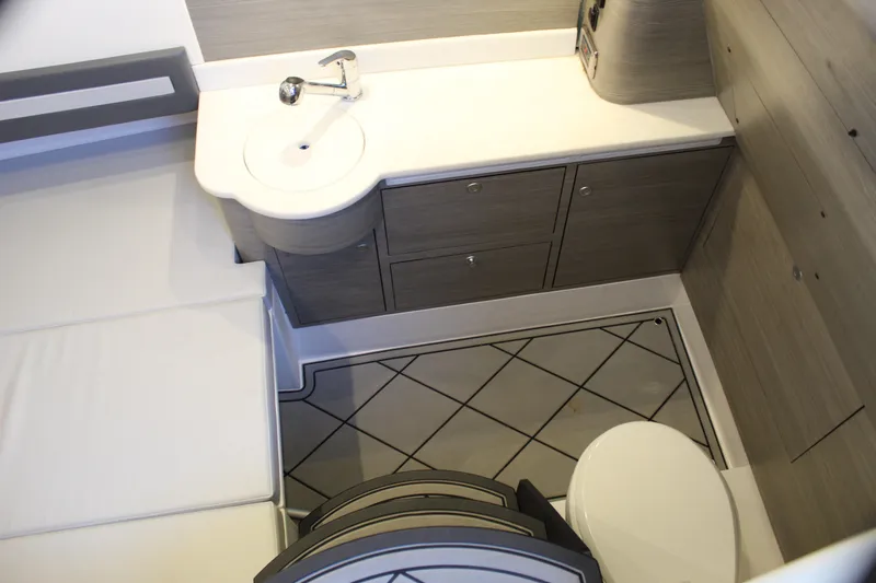  Yacht Photos Pics Modern bathroom interior in 2021 Mystic M4200 boat, featuring sleek cabinetry and compact design.