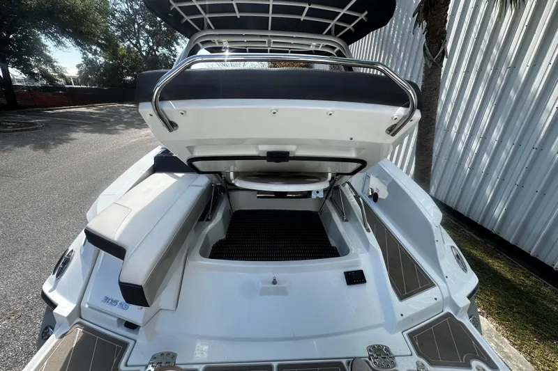  Yacht Photos Pics 2023 Monterey 305SS Super Sport boat with open storage compartment, sleek design.