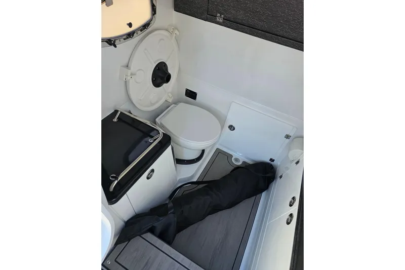  Yacht Photos Pics 2026 Monterey Elite 30 OB boat interior with compact bathroom and storage area.