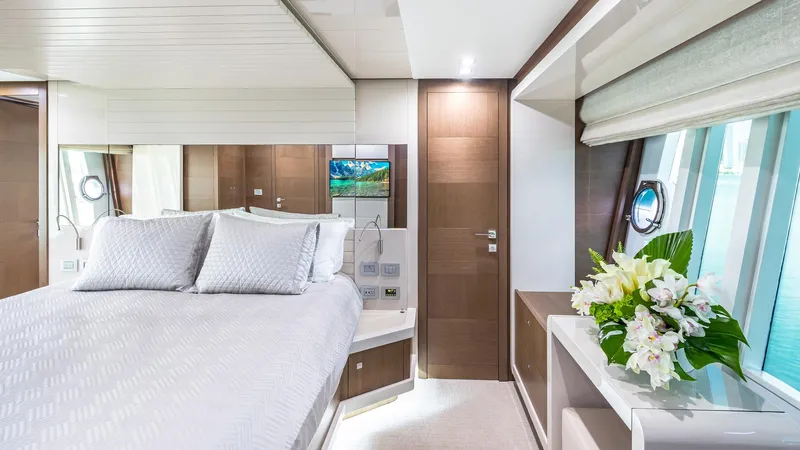 Hoya Saxa Yacht Photos Pics Luxurious bedroom interior of 2013 Ferretti Yachts 870 FLYBRIDGE with elegant decor and ocean view.
