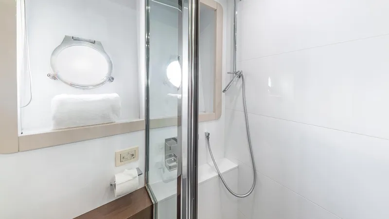 Hoya Saxa Yacht Photos Pics Luxurious bathroom in 2013 Ferretti Yachts 870 FLYBRIDGE with modern shower and porthole window.