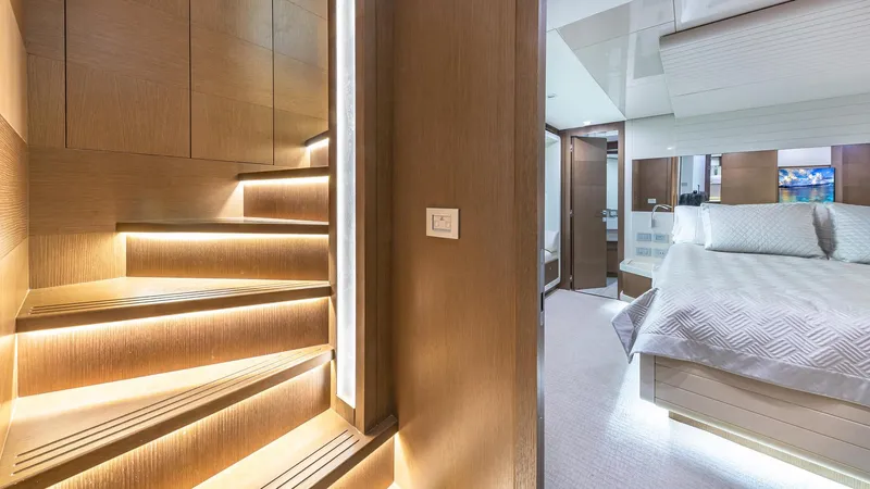 Hoya Saxa Yacht Photos Pics Luxurious interior of 2013 Ferretti Yachts 870 FLYBRIDGE with illuminated stairs and elegant bedroom.