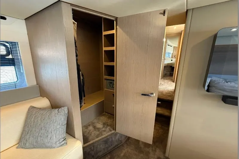  Yacht Photos Pics Luxurious interior of 2022 Azimut Fly 53 yacht with open closet and seating area.