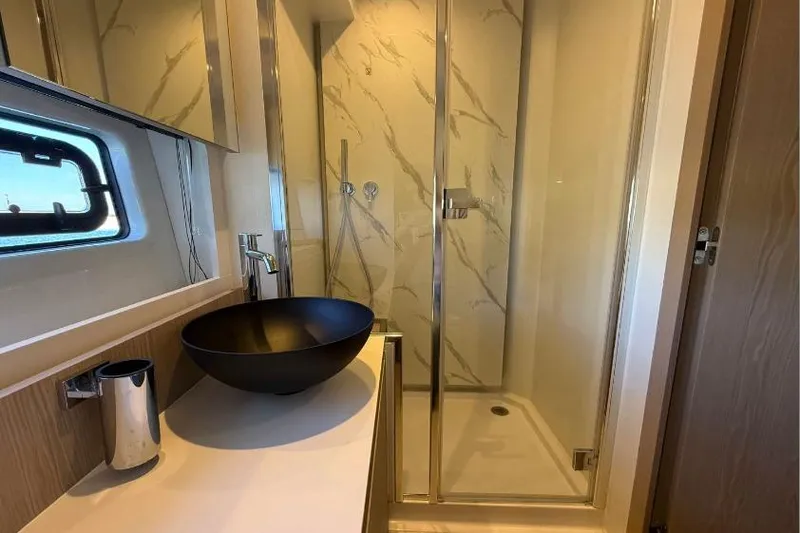  Yacht Photos Pics Luxurious bathroom in 2022 Azimut Fly 53 yacht with modern sink and glass shower.
