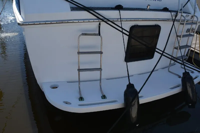 Aloha Yacht Photos Pics 1988 Marine Trader 47 Tradewinds yacht stern with ladder and fenders.