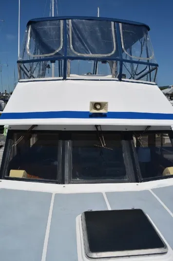 Aloha Yacht Photos Pics 1988 Marine Trader 47 Tradewinds yacht with blue accents and clear canopy.