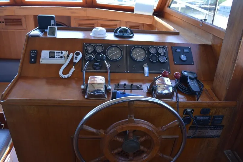 Aloha Yacht Photos Pics Helm of 1988 Marine Trader 47 Tradewinds with wooden wheel and navigation instruments.