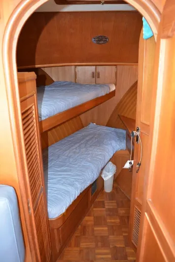 Aloha Yacht Photos Pics 1988 Marine Trader 47 Tradewinds cabin with wooden interior and bunk beds.