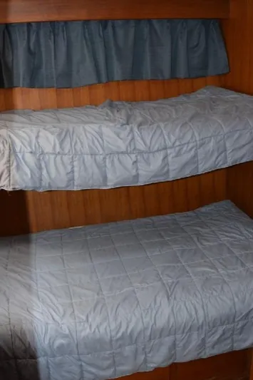 Aloha Yacht Photos Pics Bunk beds in 1988 Marine Trader 47 Tradewinds yacht cabin, with blue curtains.