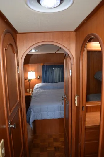 Aloha Yacht Photos Pics 1988 Marine Trader 47 Tradewinds cabin interior with wood paneling and cozy bed.