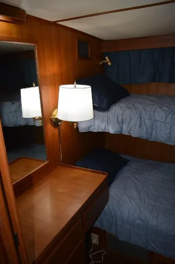 Aloha Yacht Photos Pics 1988 Marine Trader 47 Tradewinds cabin with bunk beds and wooden interior.