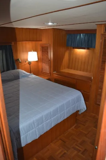 Aloha Yacht Photos Pics 1988 Marine Trader 47 Tradewinds cabin with wood paneling and cozy bed.