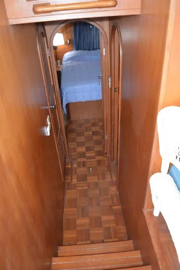 Aloha Yacht Photos Pics 1988 Marine Trader 47 Tradewinds interior with wood paneling and cozy bedroom view.