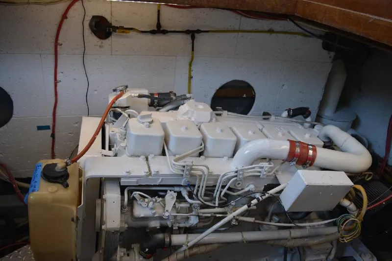 Aloha Yacht Photos Pics Engine room of 1988 Marine Trader 47 Tradewinds yacht, showcasing engine components and wiring.