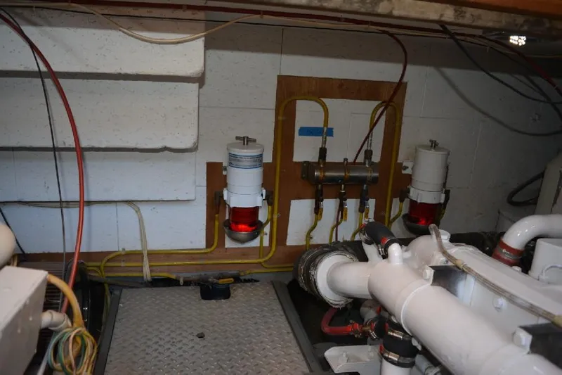 Aloha Yacht Photos Pics Engine room of 1988 Marine Trader 47 Tradewinds with fuel filters and piping.