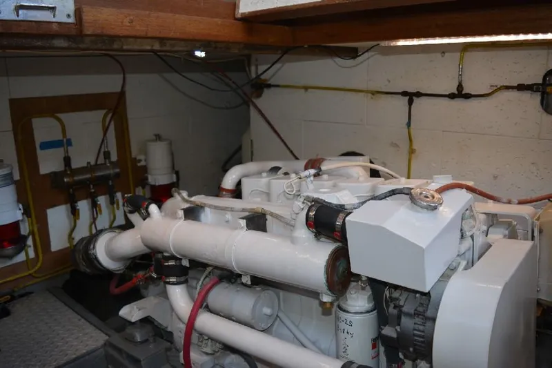 Aloha Yacht Photos Pics Engine room of 1988 Marine Trader 47 Tradewinds yacht, showcasing mechanical components and wiring.