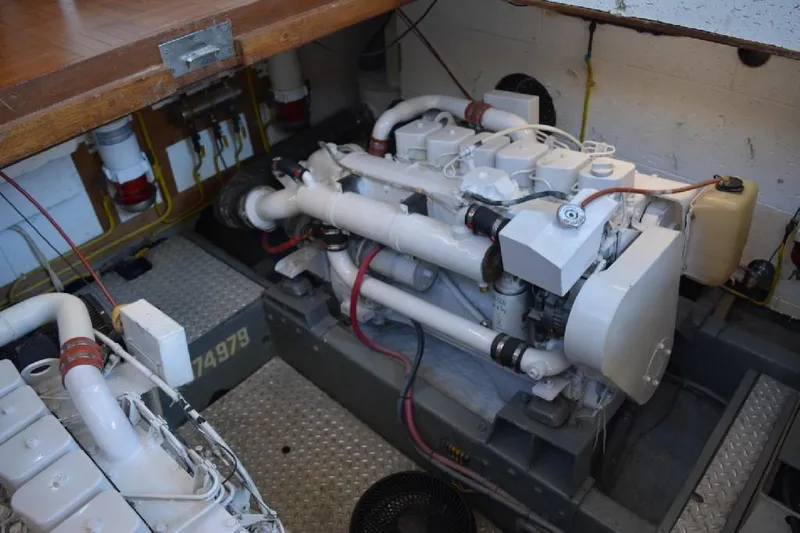 Aloha Yacht Photos Pics Engine room of 1988 Marine Trader 47 Tradewinds yacht, showcasing mechanical components.