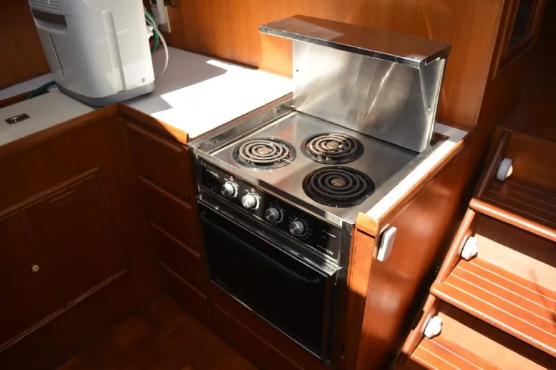 Aloha Yacht Photos Pics Galley kitchen in 1988 Marine Trader 47 Tradewinds yacht with stove and oven.