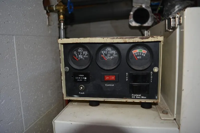 Aloha Yacht Photos Pics Control panel of a 1988 Marine Trader 47 Tradewinds boat, featuring gauges and switches.