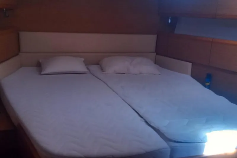  Yacht Photos Pics Cozy cabin bedroom in 2010 Jeanneau 53 yacht with double bed and pillows.