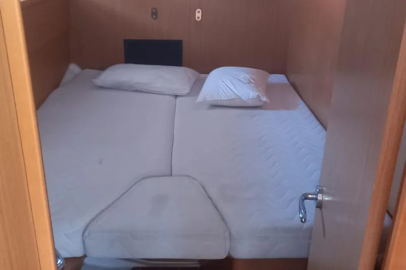  Yacht Photos Pics Cabin interior of 2010 Jeanneau 53 yacht with double bed and pillows.
