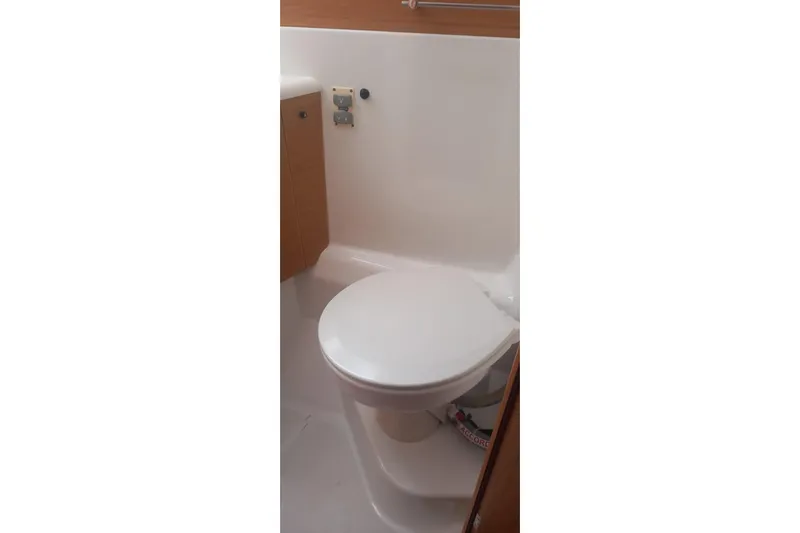  Yacht Photos Pics Toilet area in 2010 Jeanneau 53 yacht, featuring compact design and wooden cabinetry.