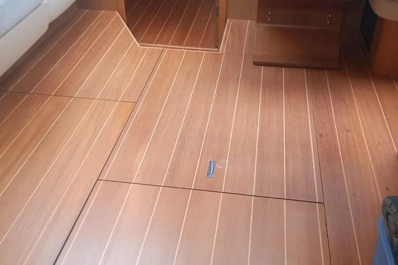  Yacht Photos Pics Wooden interior flooring of a 2010 Jeanneau 53 yacht, showcasing elegant craftsmanship.