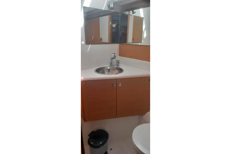  Yacht Photos Pics Bathroom interior of 2010 Jeanneau 53 yacht with sink and mirror.
