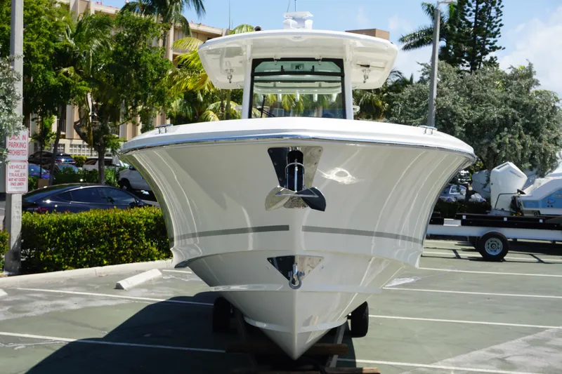 Bwce1064l324 Yacht Photos Pics 2024 Boston Whaler 330 Outrage boat in a parking lot, front view.