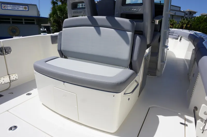 Bwce1064l324 Yacht Photos Pics 2024 Boston Whaler 330 Outrage boat seating area with storage compartment.
