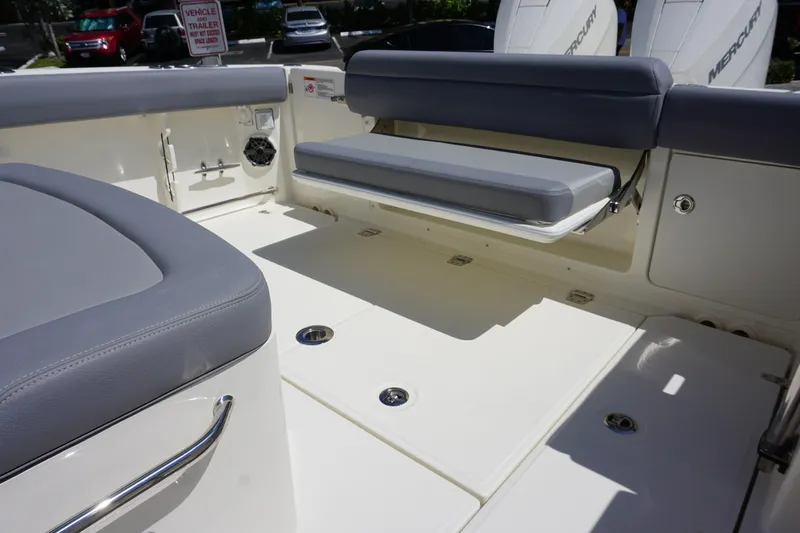 Bwce1064l324 Yacht Photos Pics 2024 Boston Whaler 330 Outrage boat interior with cushioned seating and storage compartments.