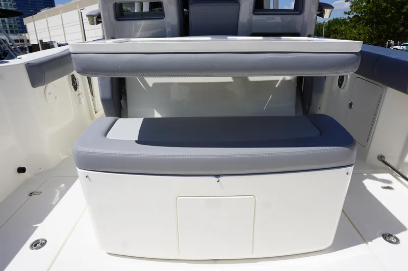 Bwce1064l324 Yacht Photos Pics 2024 Boston Whaler 330 Outrage boat seating area with storage compartment.