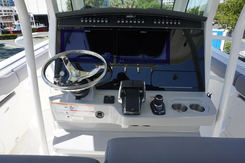 Bwce1064l324 Yacht Photos Pics 2024 Boston Whaler 330 Outrage helm with dual screens and modern controls.