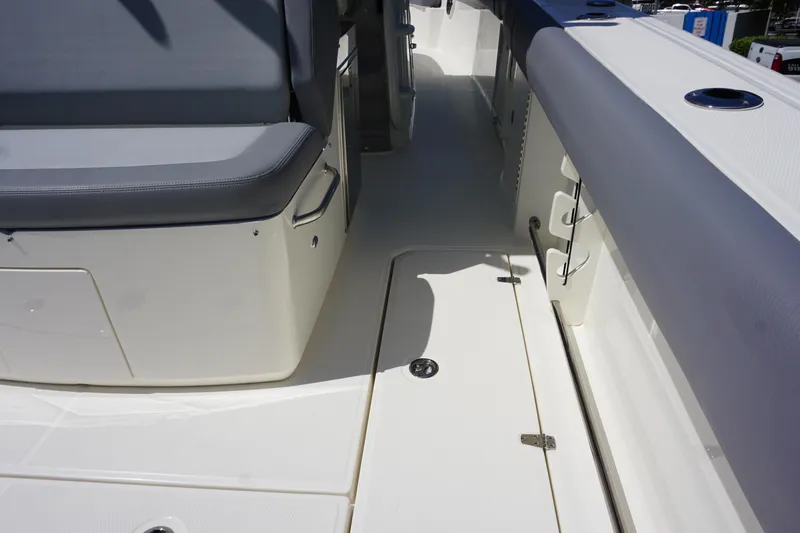 Bwce1064l324 Yacht Photos Pics 2024 Boston Whaler 330 Outrage boat interior, featuring seating and storage compartments.