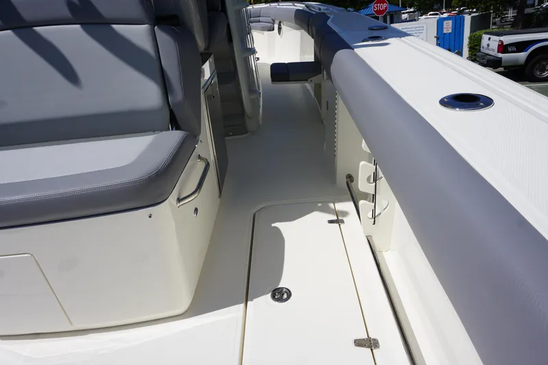 Bwce1064l324 Yacht Photos Pics 2024 Boston Whaler 330 Outrage boat interior with seating and storage compartments.