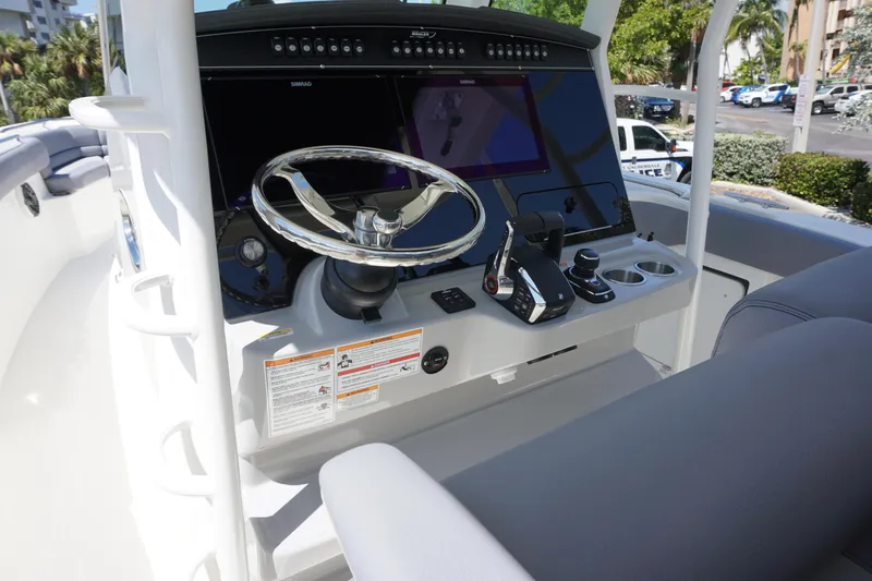 Bwce1064l324 Yacht Photos Pics 2024 Boston Whaler 330 Outrage boat helm with steering wheel and control panel.