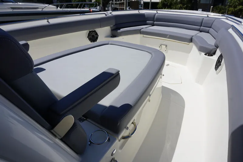 Bwce1064l324 Yacht Photos Pics 2024 Boston Whaler 330 Outrage boat interior with cushioned seating and cup holders.