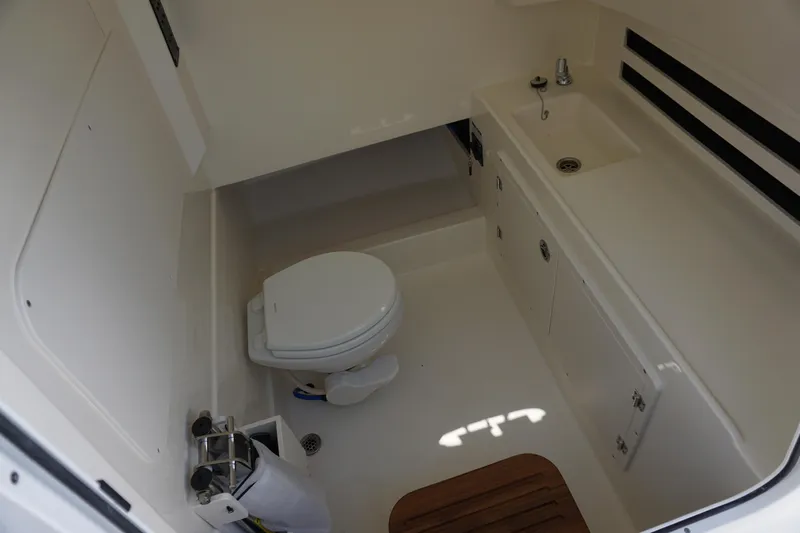 Bwce1064l324 Yacht Photos Pics 2024 Boston Whaler 330 Outrage boat interior bathroom with toilet and sink.