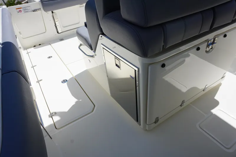 Bwce1064l324 Yacht Photos Pics 2024 Boston Whaler 330 Outrage boat interior with seating and storage compartments.