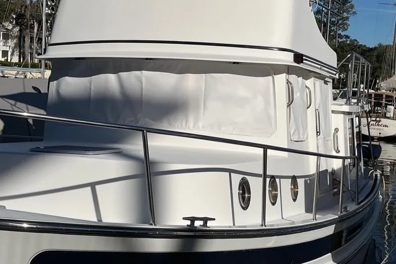Egret Yacht Photos Pics 2005 Nordic Tug 37 Flybridge boat with white exterior and railings in a marina.
