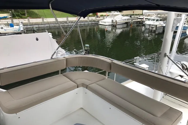 Egret Yacht Photos Pics Flybridge seating on 2005 Nordic Tug 37, overlooking marina with docked boats.