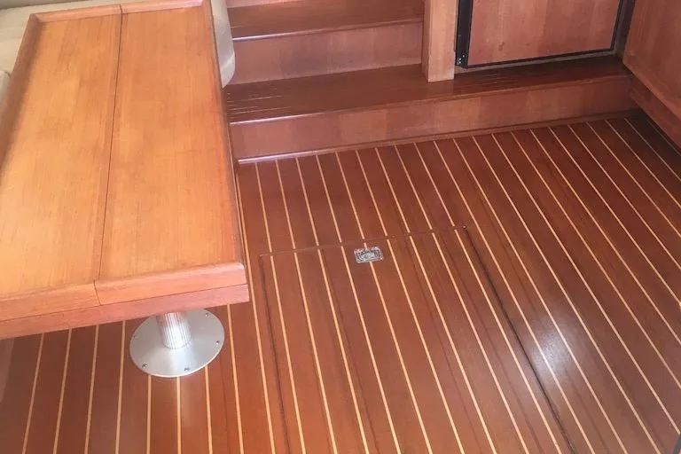 Egret Yacht Photos Pics Interior of 2005 Nordic Tug 37 Flybridge with polished wooden flooring and seating.