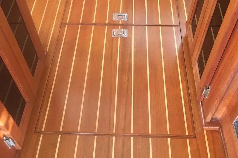 Egret Yacht Photos Pics Teak flooring on 2005 Nordic Tug 37 Flybridge, featuring elegant wood grain and metal handles.