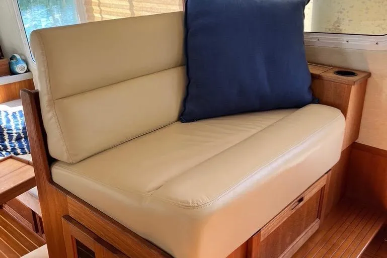 Egret Yacht Photos Pics Companion Seating in Pilothouse to port side featuring Beige Ultraleather seating with blue cushion on 2005 Nordic Tug 37 Flybridge yacht interior.