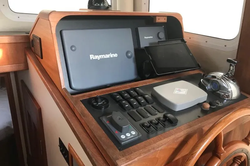 Egret Yacht Photos Pics Lower Helm of 2005 Nordic Tug 37 Flybridge with navigation equipment, engine control, bow and stern thruster control..